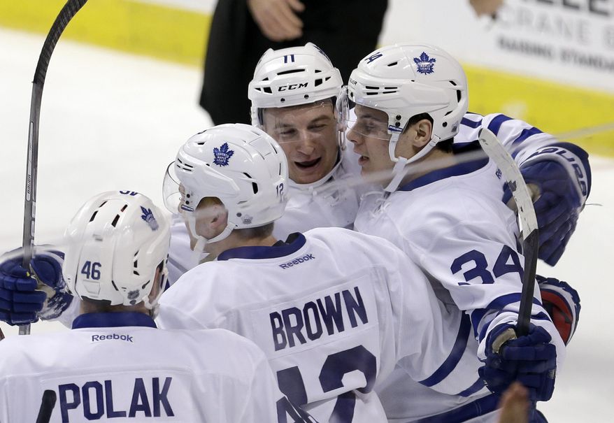 Toronto Maple Leafs center Auston Matthews (34) is congratulated by teammates after scoring against the Florida Panthers during the first period of an NHL hockey game, Wednesday, Dec. 28, 2016, in Sunrise, Fla. (AP Photo/Alan Diaz)