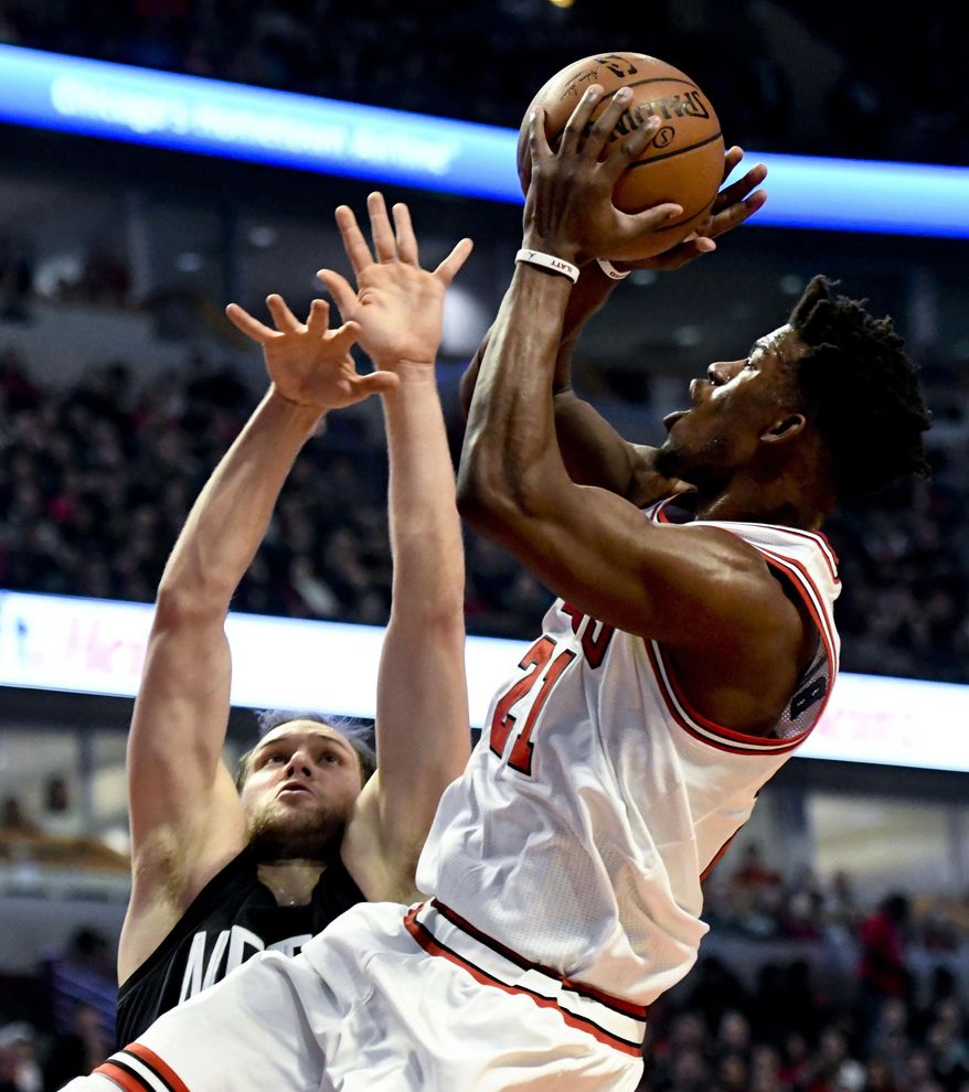 Chicago Bulls forward Jimmy Butler (21) shoots against Brooklyn Nets guard Bojan Bogdanovic, left, during the first half of an NBA basketball game Wednesday, Dec. 28, 2016, in Chicago. (AP Photo/Matt Marton)