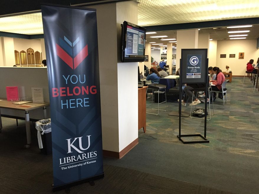 In this Nov. 30, 2016 photo, a sign advertising the University of Kansas Libraries' "You Belong Here" campaign is displayed at the university's Watson Library, in Lawrence, Kansas. The campaign is aimed at making undergraduates, including those who are transgender, feel welcome. (Sara Shepherd /The Lawrence Journal-World via AP)