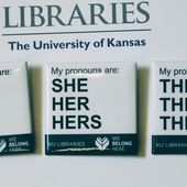 In this Tuesday, Dec. 27, 2016 photo, buttons advertising part of the University of Kansas Libraries&#x27; &amp;quot;You Belong Here&amp;quot; campaign are displayed in Lawrence, Kansas. The campaign is aimed at making undergraduates, including those who are transgender, feel welcome. A number of University of Kansas Libraries employees now wear the buttons showing their preferred gender pronouns. (Sara Shepherd /The Lawrence Journal-World via AP) **FILE**