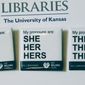 In this Tuesday, Dec. 27, 2016 photo, buttons advertising part of the University of Kansas Libraries&#39; &amp;quot;You Belong Here&amp;quot; campaign are displayed in Lawrence, Kansas. The campaign is aimed at making undergraduates, including those who are transgender, feel welcome. A number of University of Kansas Libraries employees now wear the buttons showing their preferred gender pronouns.  (Sara Shepherd /The Lawrence Journal-World via AP)
