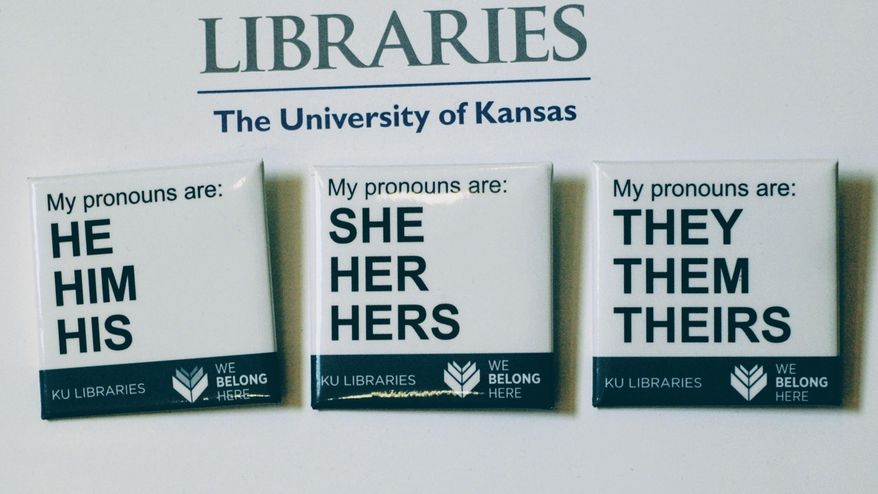 In this Tuesday, Dec. 27, 2016 photo, buttons advertising part of the University of Kansas Libraries&#39; &amp;quot;You Belong Here&amp;quot; campaign are displayed in Lawrence, Kansas. The campaign is aimed at making undergraduates, including those who are transgender, feel welcome. A number of University of Kansas Libraries employees now wear the buttons showing their preferred gender pronouns. (Sara Shepherd /The Lawrence Journal-World via AP) **FILE**