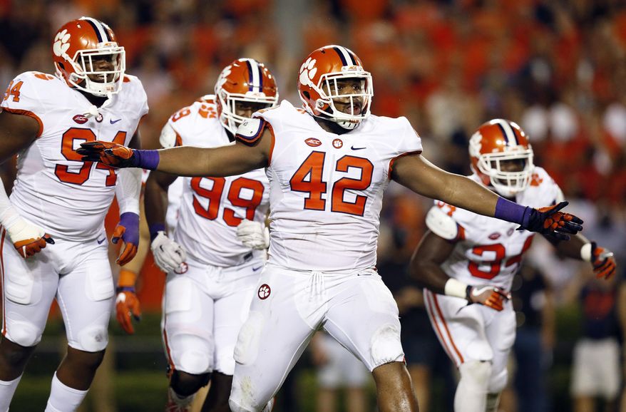 FILE - In this Sept. 3, 2016, file photo, Clemson defensive lineman Christian Wilkins celebrates after a Clemson sack of Auburn quarterback Jeremy Johnson during the first half of an NCAA college football game in Auburn, Ala. As part of the Tigers’ “Jumbo Package,” Clemson lines up the 6-foot-5 Lawrence and 6-4, 310-pound defensive end Christian Wilkins in the backfield for goal line or short yardage situations. (AP Photo/Brynn Anderson, File)