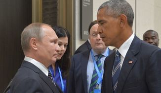 Russian President Vladimir Putin speaks with President Obama in Hangzhou, China, on Sept. 5, 2016 in this file photo. (Associated Press) **FILE**