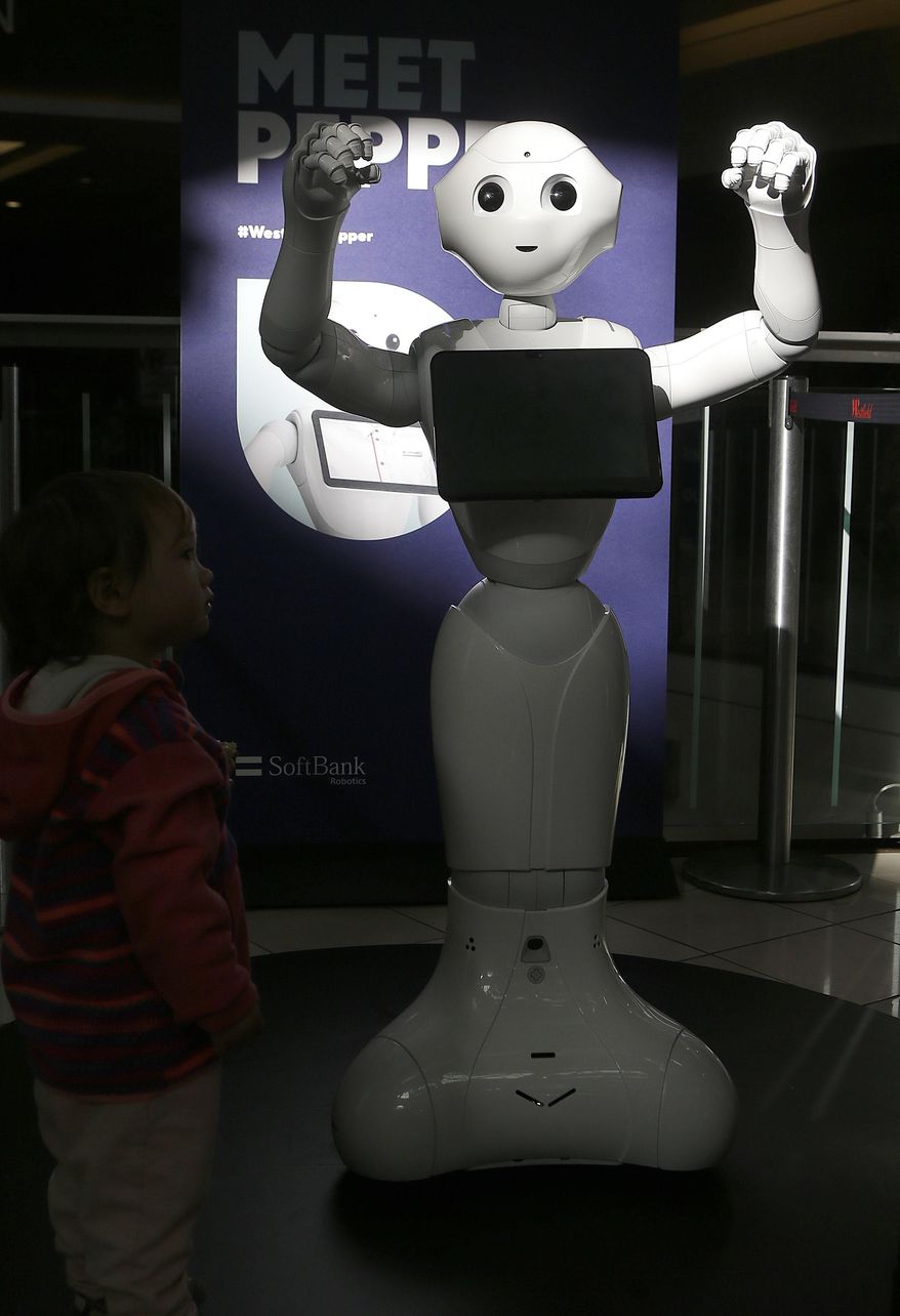 This Thursday, Dec. 22, 2016, photo, shows Pepper the robot at Westfield Mall in San Francisco. While merrily chirping, dancing and posing for selfies, Pepper looks like another expensive toy in the San Francisco mall where it will be entertaining shoppers through mid-February. But it would be a mistake to dismiss Pepper as mere child's play, even though kids flock around the 4-foot-tall humanoid as it speaks in a cherubic voice that could belong to either a boy or girl. (AP Photo/Jeff Chiu)