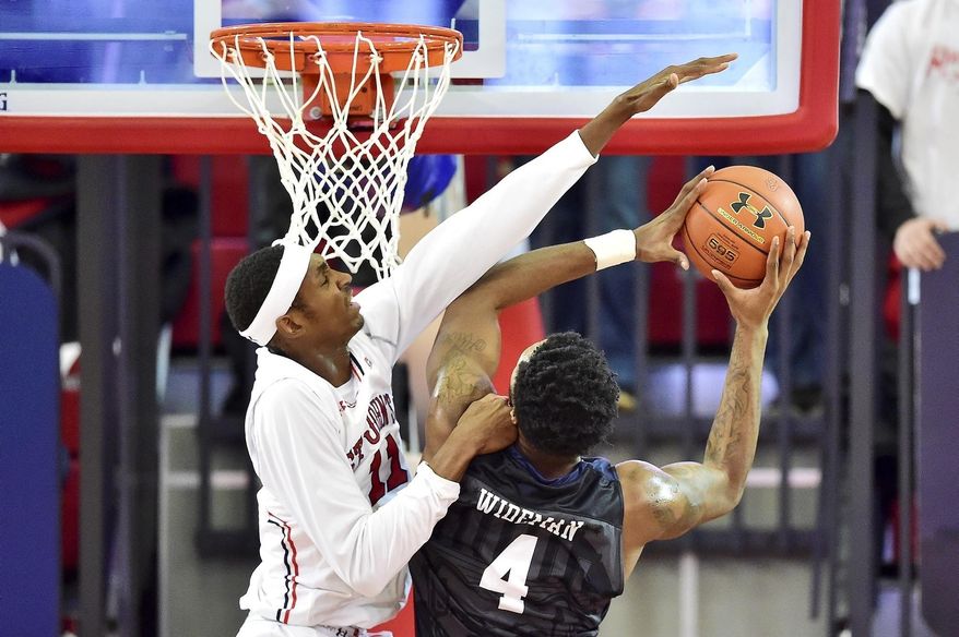 Butler's Tyler Wideman (4) has his shot blocked by St. John's Tariq Owens during an NCAA college basketball game in New York, Thursday, Dec. 29, 2016. (Steven Ryan/Newsday via AP) /
