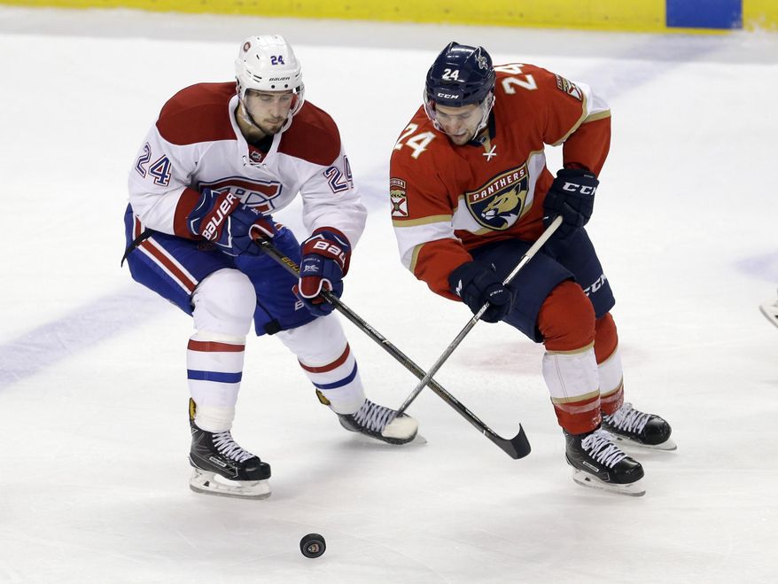 Montreal Canadiens left wing Phillip Danault, left, battles Florida Panthers center Seth Griffith, right, for the puck during the second period of an NHL hockey game, Thursday, Dec. 29, 2016, in Sunrise, Fla. (AP Photo/Alan Diaz)