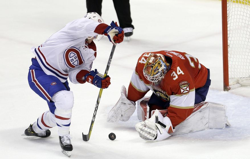 Florida Panthers goalie James Reimer (34) stops a shot by Montreal Canadiens left wing Daniel Carr, left, during the first period of an NHL hockey game, Thursday, Dec. 29, 2016, in Sunrise, Fla. (AP Photo/Alan Diaz)