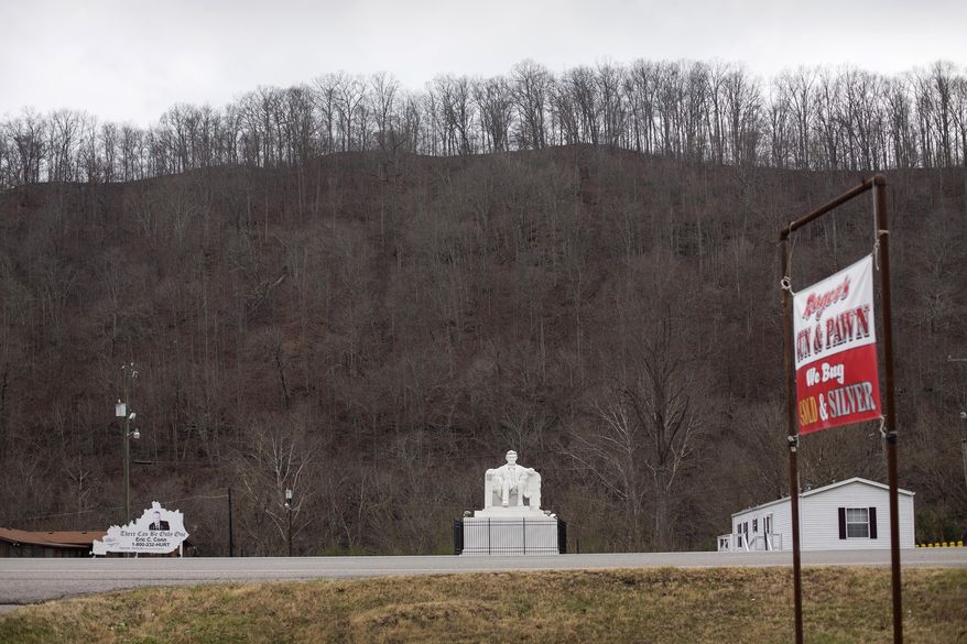 ADVANCE FOR USE FRIDAY, DEC. 30, 2016 AND THEREAFTER-This Monday, Dec. 19, 2016 photo shows a sculpture of Abraham Lincoln outside the law offices of Eric C. Conn in Stanville, Ky. Many of Conn's clients have lost their Social Security disability checks after he became the subject of a federal fraud investigation. (AP Photo/David Stephenson)