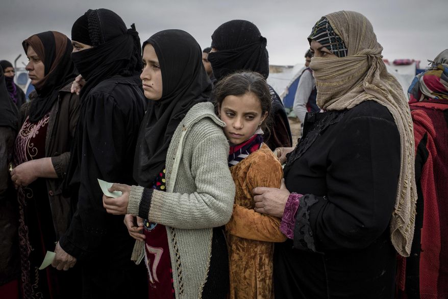 Iraqis displaced from Mosul receive aid distributions at near Qayara, Iraq on Wednesday, Dec. 28, 2016. (AP Photo/Cengiz Yar)