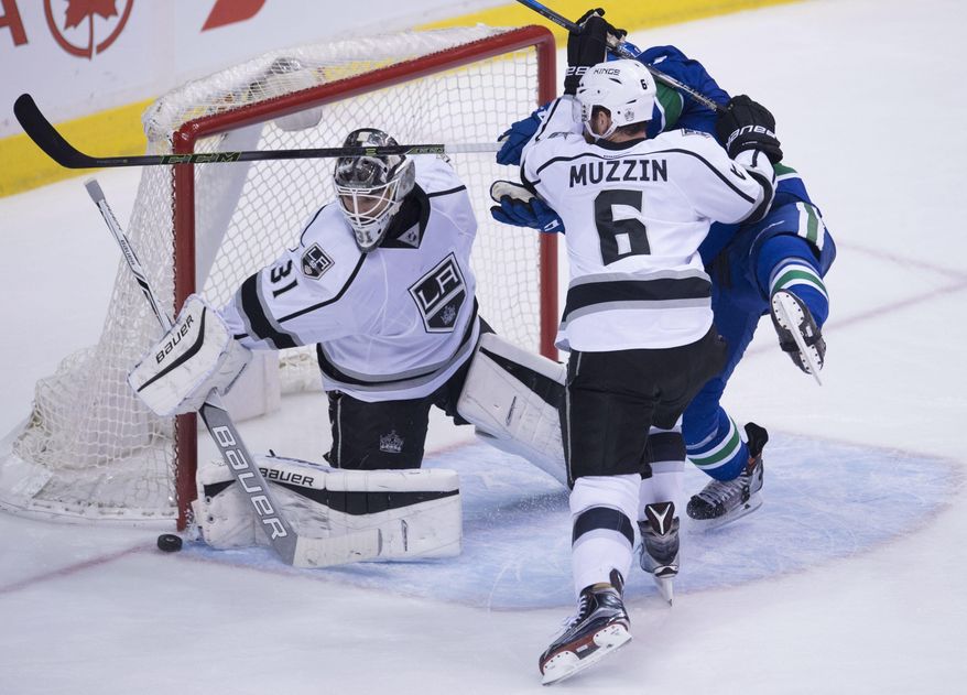 Los Angeles Kings defenseman Jake Muzzin (6) tries to clear Vancouver Canucks right wing Jack Skille (9) from in front of Kings goalie Peter Budaj (31) during the third period of an NHL hockey game Wednesday, Dec. 28, 2016, in Vancouver, British Columbia. (Jonathan Hayward/The Canadian Press via AP)