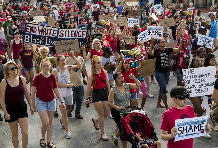 FILE - In this Saturday, July 9, 2016 file photo, Black Lives Matter supporters march after a gathering in Loring Park in Minneapolis, Minn. The movement denounces the shootings of unarmed black men by police officers. (Isaac Hale/Star Tribune via AP)