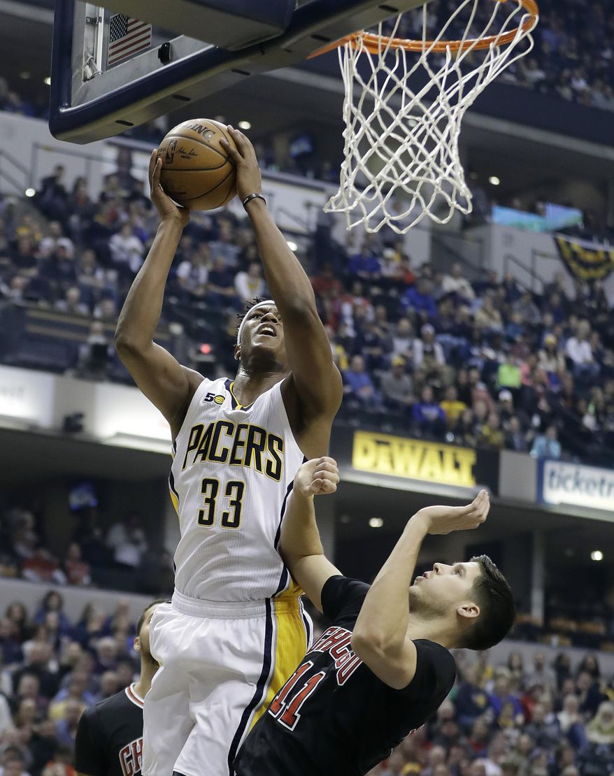 Indiana Pacers' Myles Turner shoots against Chicago Bulls' Doug McDermott, right, during the first half of an NBA basketball game Friday, Dec. 30, 2016, in Indianapolis. (AP Photo/Darron Cummings)