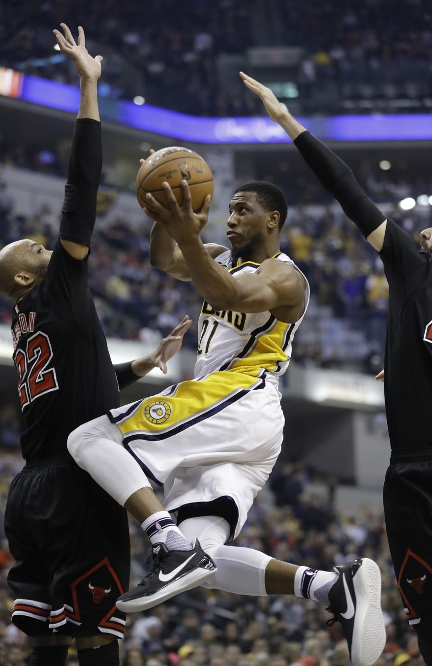 Indiana Pacers' Thaddeus Young puts up a shot against Chicago Bulls' Taj Gibson, left, during the first half of an NBA basketball game Friday, Dec. 30, 2016, in Indianapolis. (AP Photo/Darron Cummings)