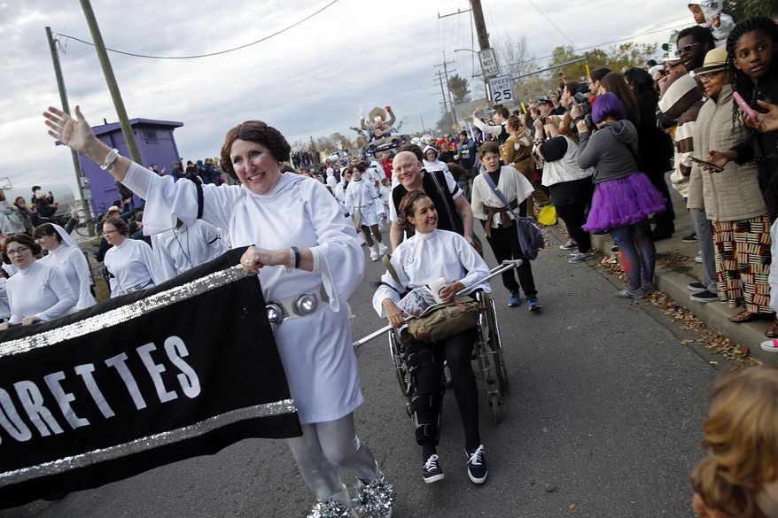 Members of the Krewe of Chewbacchus, a Mardi Gras Krewe, hold a parade with members dressed as Princess Leia, in honor of actress Carrie Fisher, who played Leia in the "Star Wars" movie series, in New Orleans, Friday, Dec. 30, 2016. Fisher died on Dec. 27, 2016, at the age of 60. (AP Photo/Gerald Herbert)