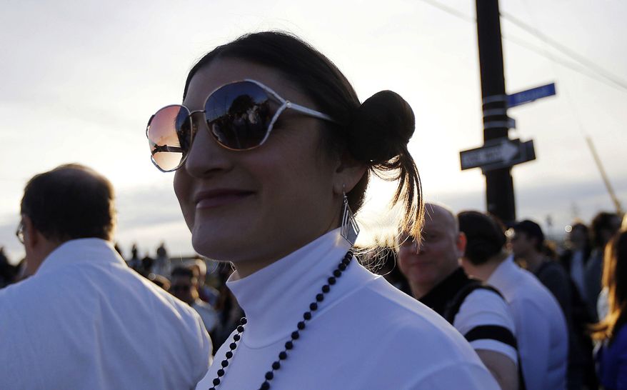 Michell Niemeyer, dressed as Princess Leia, silhouetted as members of the Krewe of Chewbacchus, a Mardi Gras Krewe, hold a parade, in honor of actress Carrie Fisher, who played her role in the "Star Wars" movie series, in New Orleans, Friday, Dec. 30, 2016. Fisher died on Dec. 27, 2016, at the age of 60. (AP Photo/Gerald Herbert)