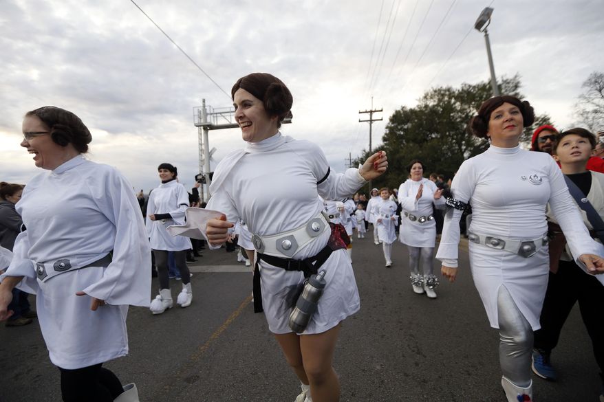 Members of the Krewe of Chewbacchus, a Mardi Gras Krewe, hold a parade with members dressed as Princess Leia, in honor of actress Carrie Fisher, who played Leia in the "Star Wars" movie series, in New Orleans, Friday, Dec. 30, 2016. Fisher died on Dec. 27, 2016, at the age of 60. (AP Photo/Gerald Herbert)