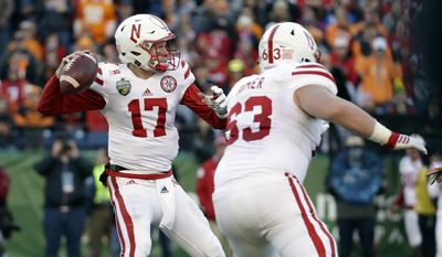 Nebraska quarterback Ryker Fyfe (17) passes as offensive lineman Tanner Farmer (63) blocks against Tennessee during the first half of the Music City Bowl NCAA college football game Friday, Dec. 30, 2016, in Nashville, Tenn. (AP Photo/Mark Humphrey)
