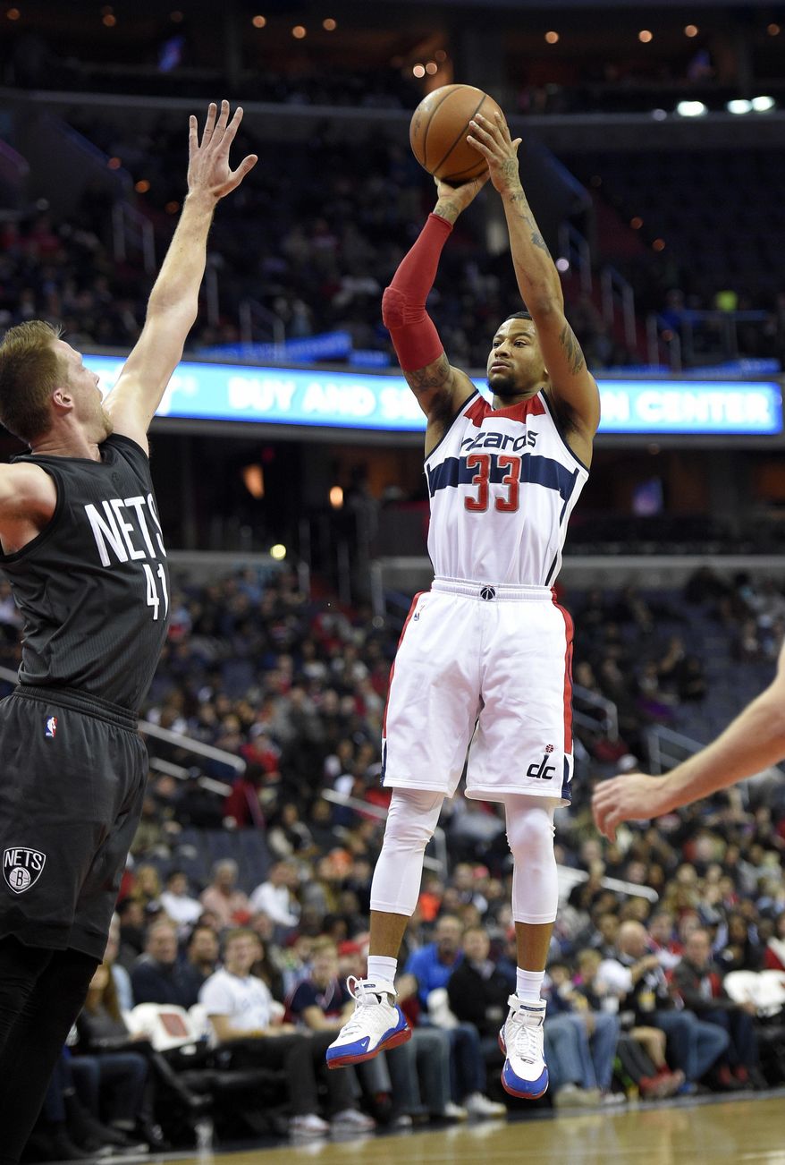 Washington Wizards guard Trey Burke (33) shoots against Brooklyn Nets center Justin Hamilton (41) during the first half of an NBA basketball game, Friday, Dec. 30, 2016, in Washington. (AP Photo/Nick Wass)