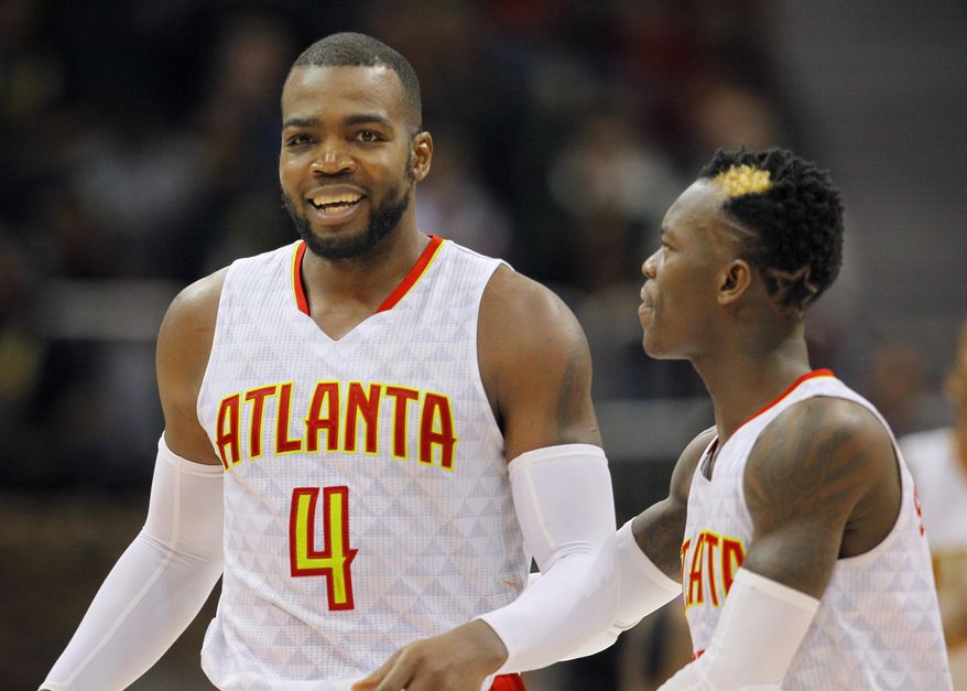 Atlanta Hawks forward Paul Millsap (4) and guard Dennis Schroder (17) reacts after Milsap scored late in the second half of an NBA basketball game between the Detroit Pistons and Atlanta Hawks on Friday, Dec. 30, 2016, in Atlanta. The Hawks won the game 105-98. (AP Photo/Todd Kirkland)