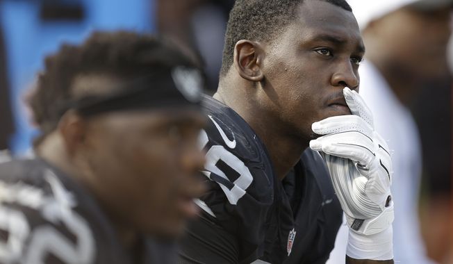 FILE - In this Sept. 13, 2015, file photo, Oakland Raiders linebacker Aldon Smith (99) sits on the bench during the second half of an NFL football game against the Cincinnati Bengals in Oakland, Calif. Suspended Oakland Raiders pass rusher Aldon Smith will not be reinstated by the NFL this season. NFL spokesman Brian McCarthy said Friday, Dec. 30, 2016,  that the league has deferred a decision on Smith&#x27;s petition for reinstatement and will begin consideration in March. (AP Photo/Ben Margot) ** FILE **