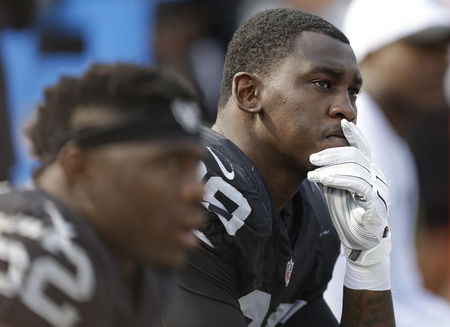 FILE - In this Sept. 13, 2015, file photo, Oakland Raiders linebacker Aldon Smith (99) sits on the bench during the second half of an NFL football game against the Cincinnati Bengals in Oakland, Calif. Suspended Oakland Raiders pass rusher Aldon Smith will not be reinstated by the NFL this season. NFL spokesman Brian McCarthy said Friday, Dec. 30, 2016, that the league has deferred a decision on Smith's petition for reinstatement and will begin consideration in March. (AP Photo/Ben Margot) ** FILE **