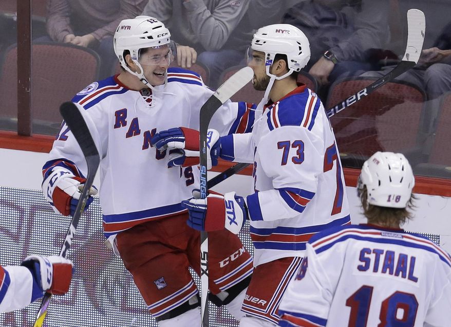 New York Rangers left wing Matt Puempel (12) celebrates with Brandon Pirri (73) after scoring his third goal of the night against the Arizona Coyotes, during the third period during an NHL hockey game, Thursday, Dec. 29, 2016, in Glendale, Ariz. (AP Photo/Rick Scuteri)
