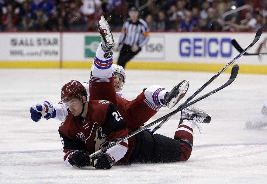 Arizona Coyotes left wing Brendan Perlini (29) and New York Rangers right wing Jesper Fast fall to the ice during the first period during of an NHL hockey game, Thursday, Dec. 29, 2016, in Glendale, Ariz. (AP Photo/Rick Scuteri)