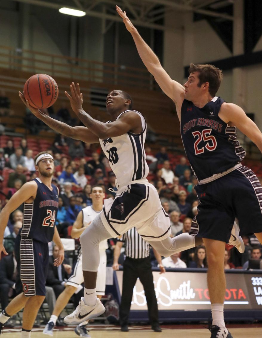 Loyola Marymount's Brandon Brown, left, tries to shoot next to Saint Mary's Joe Rahon during the first half of an NCAA college basketball game Thursday, Dec. 29, 2016, in Los Angeles. (AP Photo/Ryan Kang)