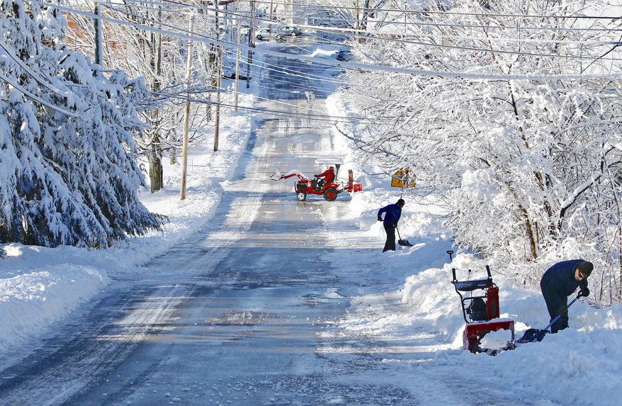 Residents along Paul Street clear snow from their driveways in South Berwick, Maine, Friday, Dec. 30, 2016, after 5-6 inches of wet, heavy snow fell overnight. The most powerful nor'easter in nearly two years brought heavy snow, powerful winds and even thunder and lightning to northern New England, leaving tens of thousands of people in the dark Friday and burying some towns under 2 feet of snow. (Jill Brady/Portland Press Herald via AP)