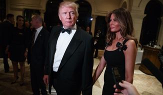 President-elect Donald Trump, left, and his wife Melania Trump arrives for a New Year&#39;s Eve party at Mar-a-Lago, Saturday, Dec. 31, 2016, in Palm Beach, Fla. (AP Photo/Evan Vucci)