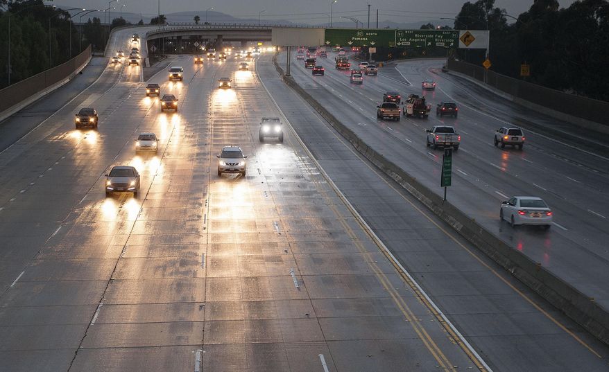 Due to most people taking the holiday week off, traffic is light on the southbound 57 freeway near the 91 interchange as a light, warm rain falls Friday morning, Dec. 30, 2016 in Anaheim. California's wet December is drawing to a close with even more rain and snow in a welcome respite amid years of drought. A warm low-pressure storm system brought showers to Southern California starting early Friday and slowly moved east through the day as a cold weather system dropped down toward the state from the north. (Ken Steinhardt/The Orange County Register via AP)