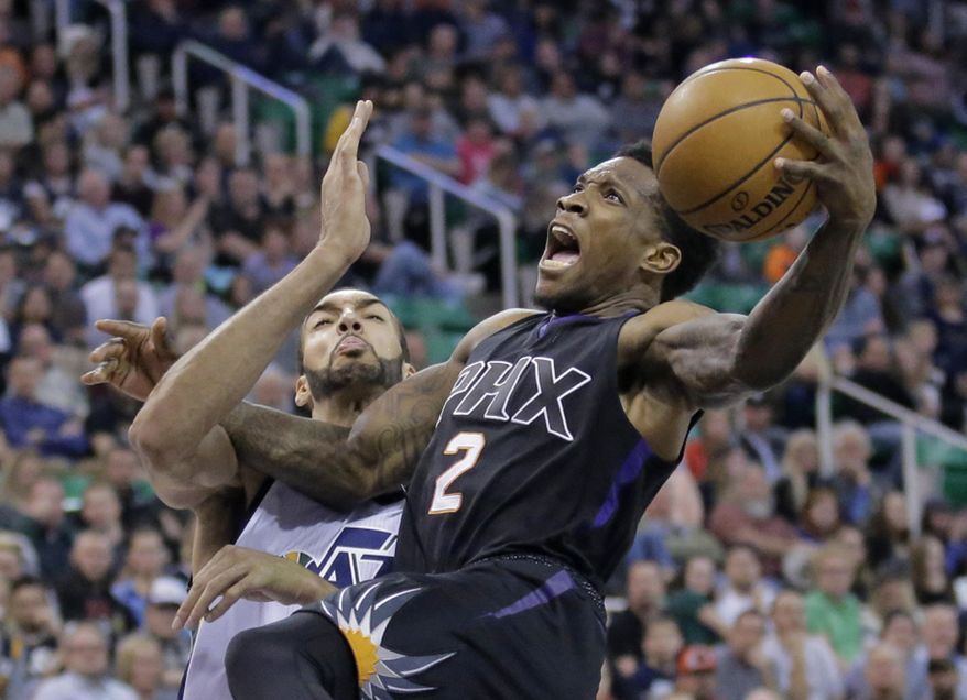 Phoenix Suns guard Eric Bledsoe (2) goes to the basket as Utah Jazz center Rudy Gobert, rear, defends in the first half during an NBA basketball game Saturday, Dec. 31, 2016, in Salt Lake City. (AP Photo/Rick Bowmer)