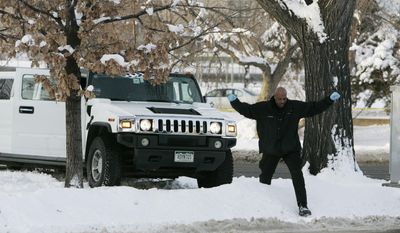 FILE - In this Monday, Jan. 1, 2007, file photo, a Denver Police Department investigator climbs over a snowbank next to a limousine in which Denver Broncos cornerback Darrent Williams was shot and killed in downtown Denver. New Year's Day marks the 10-year anniversary of Williams' death following a confrontation between Broncos players and gang members at a nightclub. (AP Photo/Ed Andrieski, File)