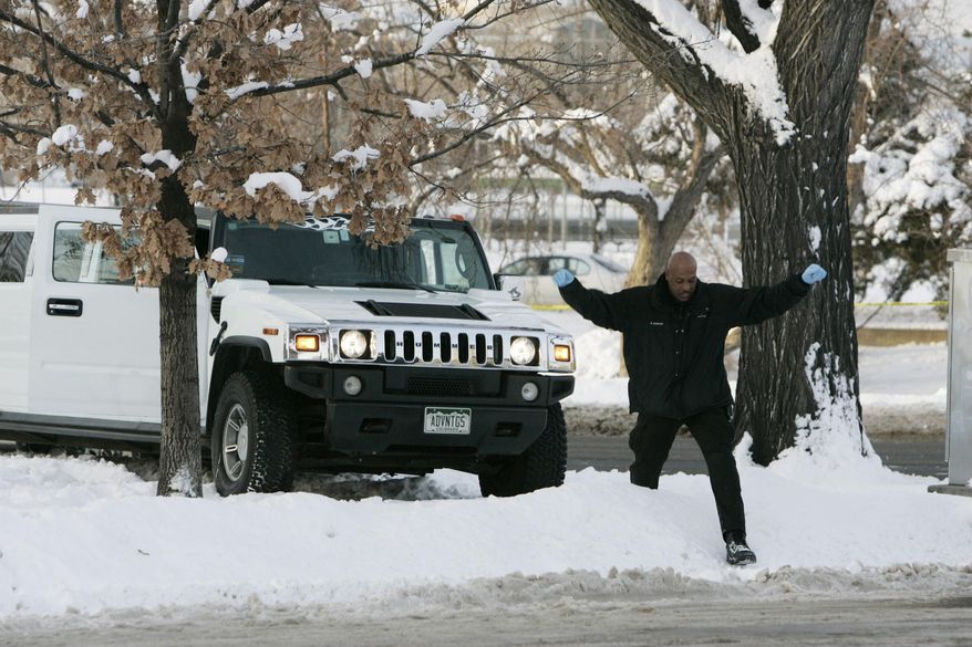 FILE - In this Monday, Jan. 1, 2007, file photo, a Denver Police Department investigator climbs over a snowbank next to a limousine in which Denver Broncos cornerback Darrent Williams was shot and killed in downtown Denver. New Year's Day marks the 10-year anniversary of Williams' death following a confrontation between Broncos players and gang members at a nightclub. (AP Photo/Ed Andrieski, File)