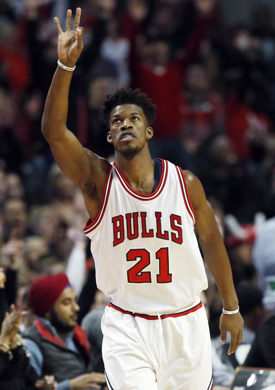Chicago Bulls guard/forward Jimmy Butler reacts after hitting a 3-point shot against the Milwaukee Bucks during the first half of an NBA basketball game Saturday, Dec. 31, 2016, in Chicago. (AP Photo/Nam Y. Huh)