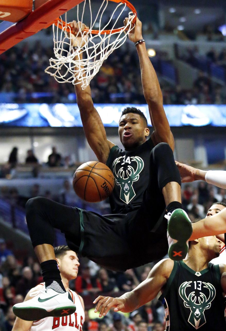 Milwaukee Bucks forward Giannis Antetokounmpo dunks against the Chicago Bulls during the first half of an NBA basketball game Saturday, Dec. 31, 2016, in Chicago. (AP Photo/Nam Y. Huh)