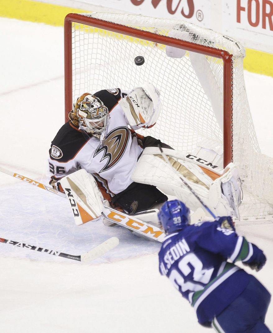 Vancouver Canucks' Henrik Sedin (33) scores against Anaheim Ducks goaltender John Gibson (36) during overtime in an NHL hockey game Friday, Dec. 30, 2016, in Vancouver, British Columbia. (Ben Nelms/The Canadian Press via AP)
