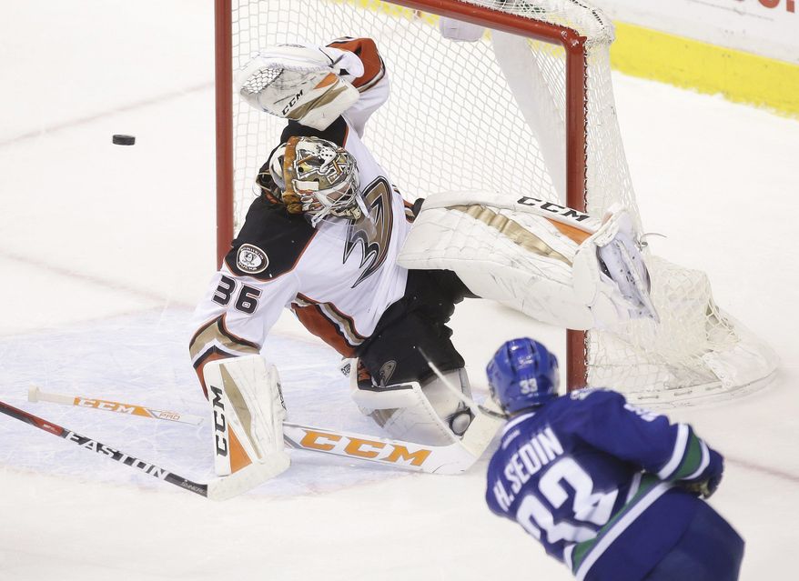 Vancouver Canucks' Henrik Sedin (33) scores against Anaheim Ducks goaltender John Gibson (36) during overtime in an NHL hockey game Friday, Dec. 30, 2016, in Vancouver, British Columbia. (Ben Nelms/The Canadian Press via AP)