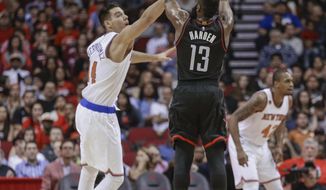 Houston Rockets guard James Harden (13) shoots over New York Knicks center Willy Hernangomez (14) during the first half of an NBA basketball game Saturday, Dec. 31, 2016, in Houston. (AP Photo/Bob Levey)