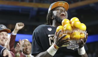Florida State running back Dalvin Cook (4) holds the Orange Bowl MVP trophy after winning the Orange Bowl NCAA college football game, Saturday, Dec. 31, 2016, in Miami Gardens, Fla. Florida State defeated Michigan 33-32. (AP Photo/Alan Diaz)