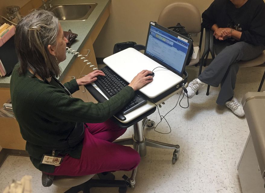 In this Dec. 21, 2016 photo, family physician Leslie Hayes interviews a pregnant 40-year-old mother (right, obscured) being treated for an addiction to heroin with the anti-craving medication Subutex, at the El Centro Family Health medical clinic in Espanola, N.M. Hayes credits her ability to effectively treat opioid addiction disorders to a training and mentoring program known as Project ECHO that is being tapped by federal officials for possible broader applications. (AP Photo/Morgan Lee)