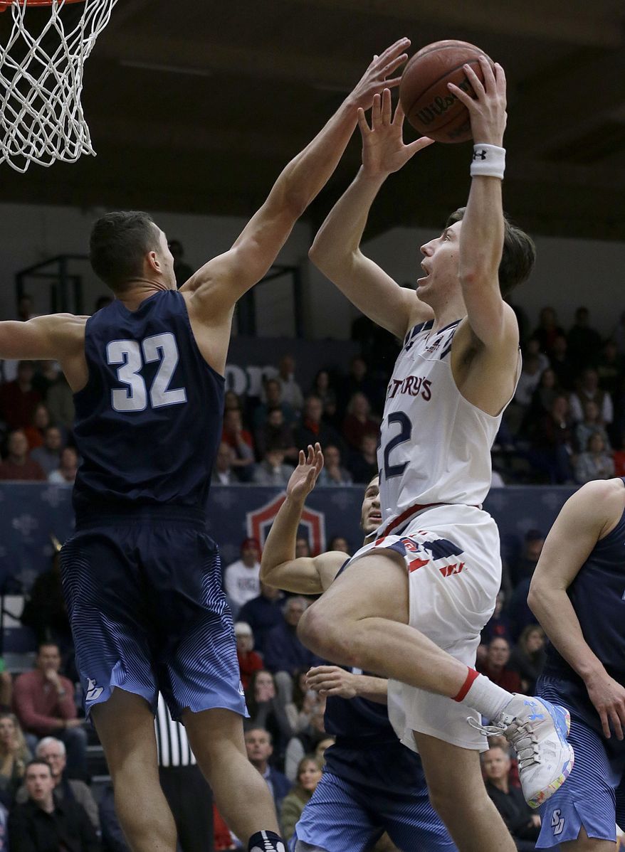 Saint Mary's forward Dane Pineau, right, shoots against San Diego forward Brett Bailey (32) during the first half of an NCAA college basketball game in Moraga, Calif., Saturday, Dec. 31, 2016. (AP Photo/Jeff Chiu)