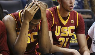 Southern California&#39;s Charles Buggs, left, holds his head in his hands next to teammate Nick Rakocevic, as Oregon wins the NCAA college basketball game 84-61 Friday, Dec. 30, 2016, in Eugene, Ore. (AP Photo/Chris Pietsch)