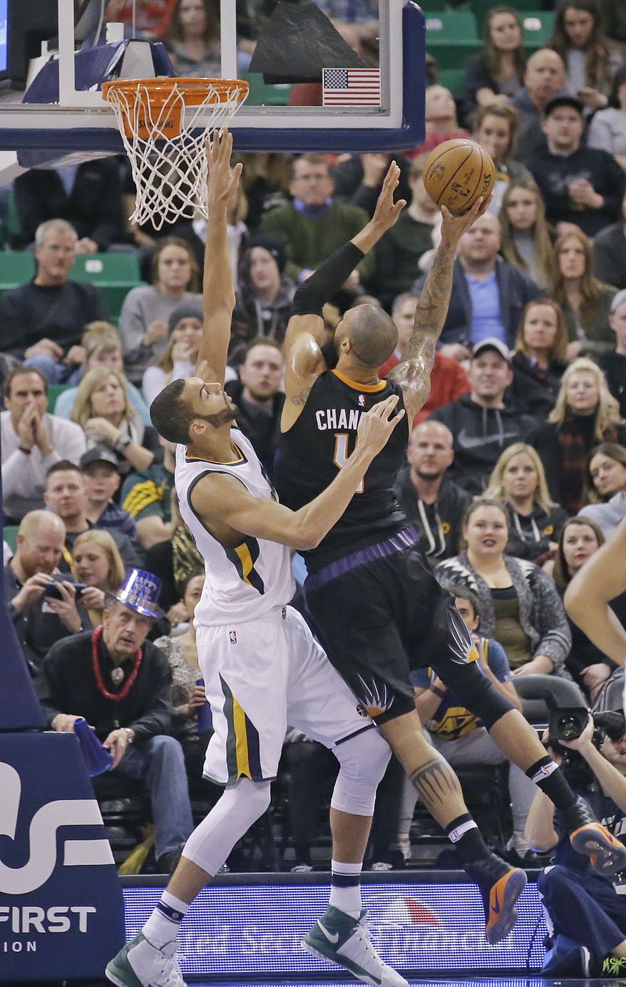 Phoenix Suns center Tyson Chandler, right, shoots as Utah Jazz center Rudy Gobert, left, defends in the first half during an NBA basketball game Saturday, Dec. 31, 2016, in Salt Lake City. (AP Photo/Rick Bowmer)