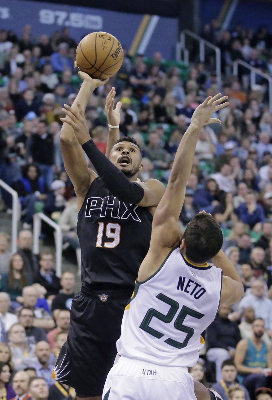Phoenix Suns guard Leandro Barbosa (19) shoots as Utah Jazz guard Raul Neto (25) defends in the first half during an NBA basketball game Saturday, Dec. 31, 2016, in Salt Lake City. (AP Photo/Rick Bowmer)