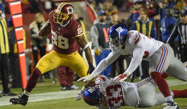 Washington Redskins wide receiver Pierre Garcon (88) breaks a tackle by New York Giants free safety Andrew Adams (33) and outside linebacker Devon Kennard (59) during the second half of an NFL football game in Landover, Md., Sunday, Jan. 1, 2017. (AP Photo/Nick Wass)