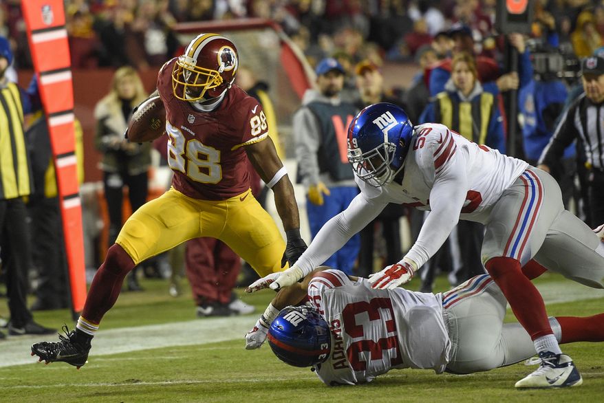 Washington Redskins wide receiver Pierre Garcon (88) breaks a tackle by New York Giants free safety Andrew Adams (33) and outside linebacker Devon Kennard (59) during the second half of an NFL football game in Landover, Md., Sunday, Jan. 1, 2017. (AP Photo/Nick Wass)