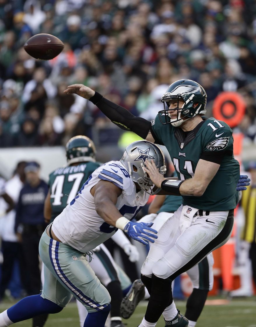 Philadelphia Eagles' Carson Wentz throws as Dallas Cowboys' Jack Crawford closes in during the second half of an NFL football game, Sunday, Jan. 1, 2017, in Philadelphia. (AP Photo/Michael Perez)