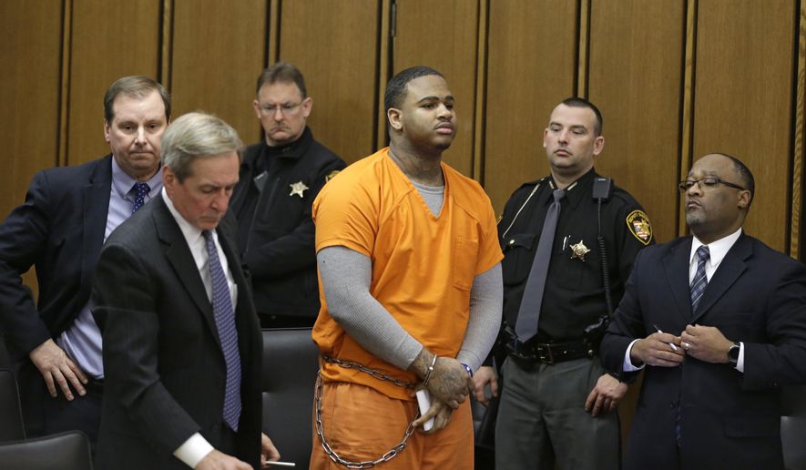 FILE - In this Monday, Dec. 19, 2016, file photo, Douglas Shine Jr., center, stands in the courtroom for sentencing in Cleveland. A decision by a Cleveland judge to overrule a jury’s death sentence recommendation for a triple killer highlights how rare such judicial decisions are. Judge Joan Synenberg cited defendant Shine’s childhood abuse as a child in sentencing him to life without parole on Dec. 19. (AP Photo/Tony Dejak, File)